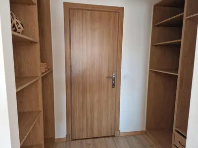 a wooden door in a room with shelves at appartement hyper centre Gueliz in Marrakech