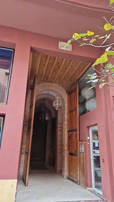 an entrance to a building with a pink wall at appartement hyper centre Gueliz in Marrakech