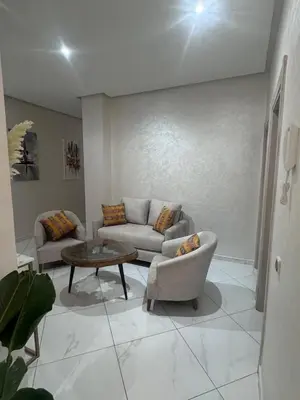 a living room with two couches and a coffee table at IMMOB Basma in Marrakech