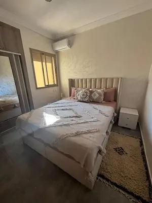 a bedroom with a large bed with a window at Nice apartment in Cherifia in Marrakech