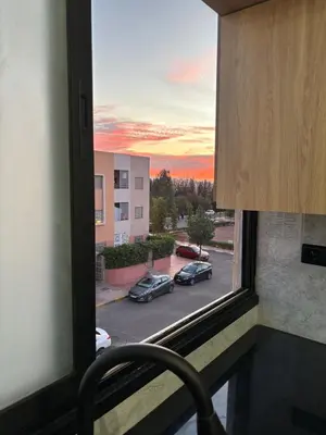 a window with a view of a parking lot at Nice apartment in Cherifia in Marrakech