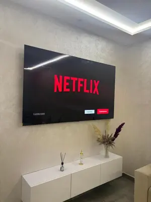 a tv on a wall with a netflix sign on it at Nice apartment in Cherifia in Marrakech