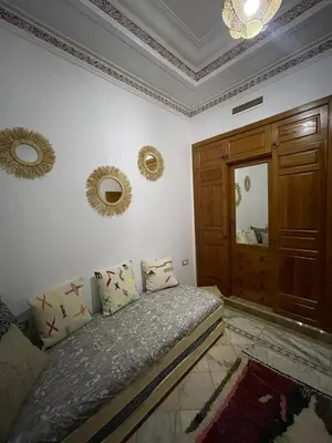 a bedroom with a bed and a mirror on the wall at Dar lala habiba in Marrakech
