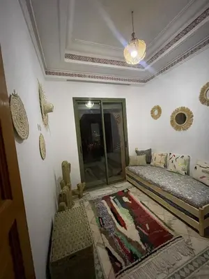 a living room with two beds and a mirror at Dar lala habiba in Marrakech