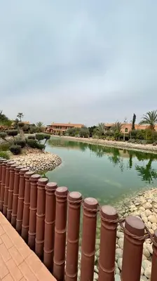 a pool of water next to a brick fence at Dar lala habiba in Marrakech