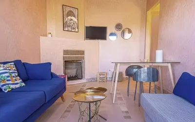 a living room with a blue couch and a table at Waky Club - Designer Flat in Marrakech
