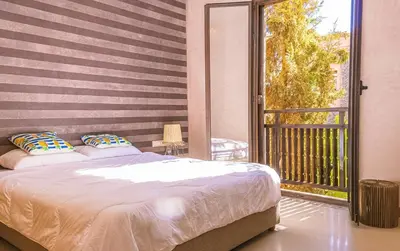 a bedroom with a bed and a balcony at Waky Club - Designer Flat in Marrakech
