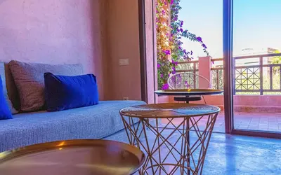 a living room with a couch and two tables at Waky Club - Designer Flat in Marrakech