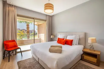a bedroom with a large white bed and a window at Heavenly Setting at Prestigia Pool in Marrakech