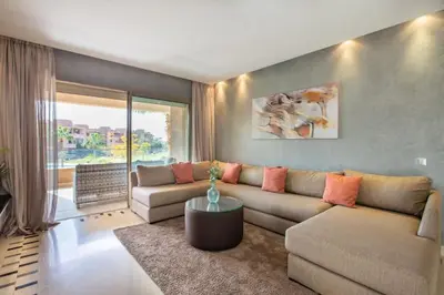 a living room with a couch and a table at Heavenly Setting at Prestigia Pool in Marrakech