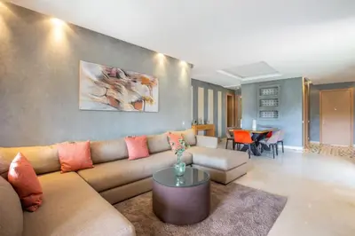 a living room with a couch and a table at Heavenly Setting at Prestigia Pool in Marrakech