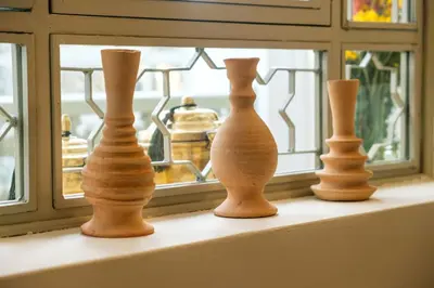 three vases sitting on a shelf in front of a window at Riad Grenade Exclusif Front Bahia in Marrakech
