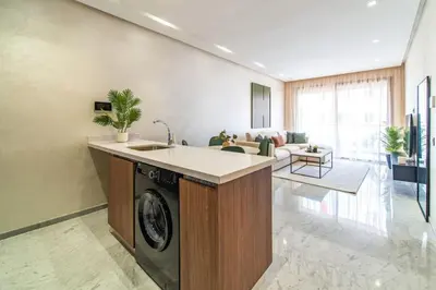 a kitchen with a washing machine in a living room at Cute and Modern in Heart of Downtown in Marrakech