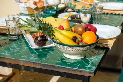 a table with a bowl of fruit on it at Riad Ines 10mn to Place with Breakfast in Marrakech