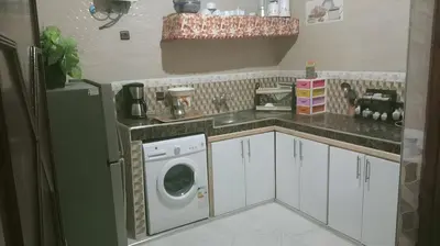 a kitchen with a washer and dryer in it at Spacious Apt - Near Airport - Perfect for Groops! in Marrakech