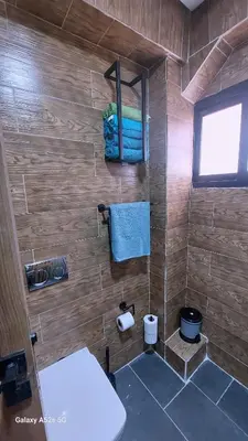 a bathroom with a shower with a blue towel at Elegant room in luxury apartment Gueliz in Marrakech