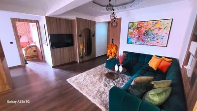 a living room with a blue couch and a tv at Elegant room in luxury apartment Gueliz in Marrakech