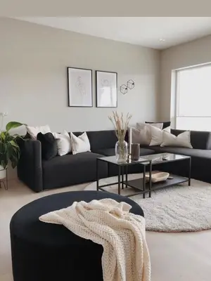 a living room with a black couch and a table at Appartement a les portes de gueliz in Marrakech