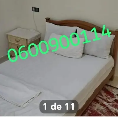a bedroom with a bed with the words ooohhhuggestuggest at شقة عائلية مجهزة للكراء اليومي مراكش in Marrakech
