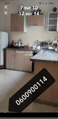 a kitchen with a sign on a counter at شقة عائلية مجهزة للكراء اليومي مراكش in Marrakech