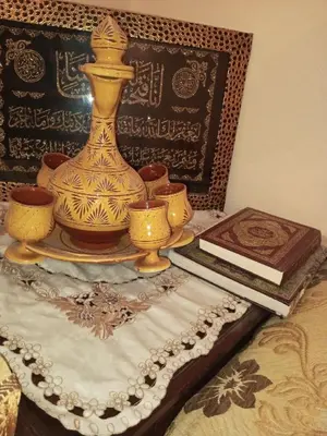 a table with a vase and books on a bed at Large 1-Bed Apt, Perfect for You! in Marrakech