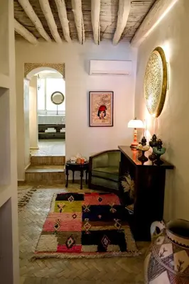 a living room with a couch and a table at Le Singe Rose & SPA in Marrakech