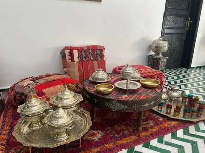 a room with a table with tea sets on a rug at Riad Zaid in Marrakech