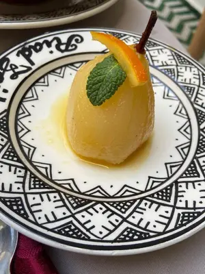 a dessert on a plate with an orange on it at Riad Zaid in Marrakech