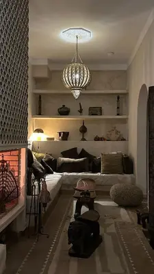 a living room with a couch and a chandelier at Riad des Sources in Marrakech