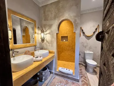 a bathroom with a sink and a toilet at Riad des Sources in Marrakech