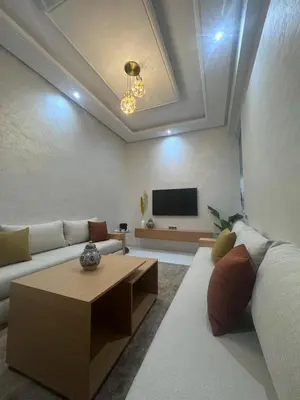 a living room with a couch and a coffee table at IMMOB Zak in Marrakech