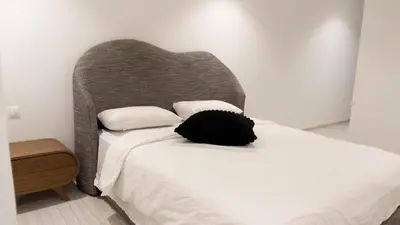 a bedroom with a bed with a headboard and pillows at IMMOB Zak in Marrakech