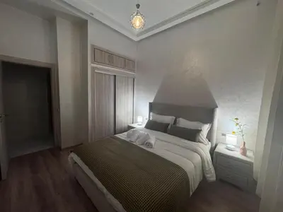 a bedroom with a large bed in a room at IMMOB Zak in Marrakech