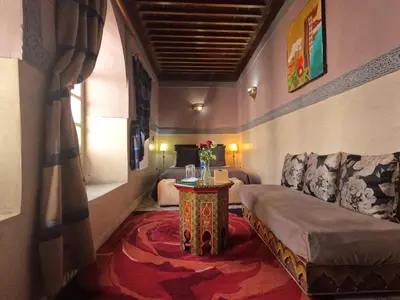a living room with a couch and a table at Riad Maizie in Marrakech