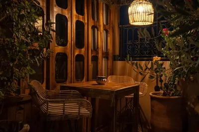 a small table and chairs in a room with plants at Riad Tassili Boutique in Marrakech
