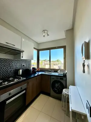 a kitchen with a washer and a sink and a dishwasher at Exceptional Golf View Apartment, Prestigia in Marrakech