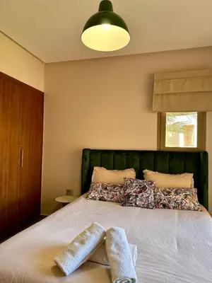 a bedroom with a bed with two towels on it at Exceptional Golf View Apartment, Prestigia in Marrakech