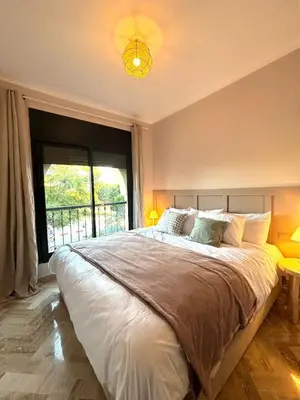 a bedroom with a large bed with a large window at Dar Sawan - Beautiful 2rooms & terrace at Atlas golf Palmeraie in Marrakech