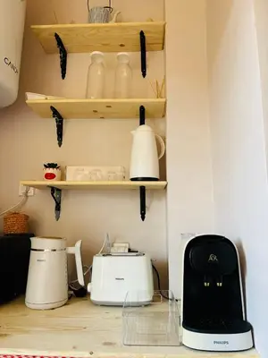 a kitchen with white appliances on shelves at Dar Sawan - Beautiful 2rooms & terrace at Atlas golf Palmeraie in Marrakech