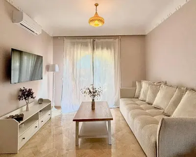 a living room with a couch and a table at Dar Sawan - Beautiful 2rooms & terrace at Atlas golf Palmeraie in Marrakech