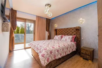 a bedroom with a bed and a large window at Perl garden in Marrakech