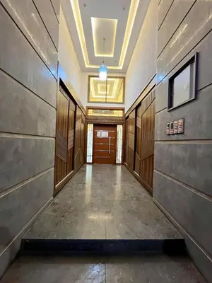a hallway of a building with wooden doors and a ceiling at T1 Chic & Bright in Marrakech in Marrakech