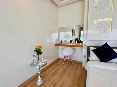 a living room with a white couch and a table at Hala Luxury Domain in Marrakech