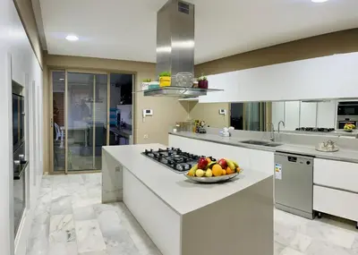 a kitchen with a bowl of fruit on a counter at Hala Luxury Domain in Marrakech