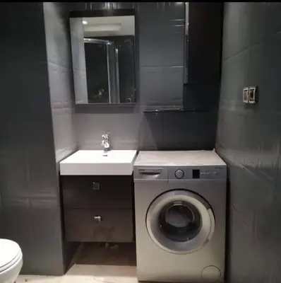 a bathroom with a washing machine and a sink at Comfortable apartment in the center of Gueliz in Marrakech