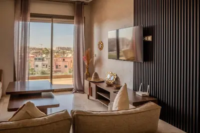 a living room with a table and a large window at City Haven at Pearl Garden Pool and View in Marrakech