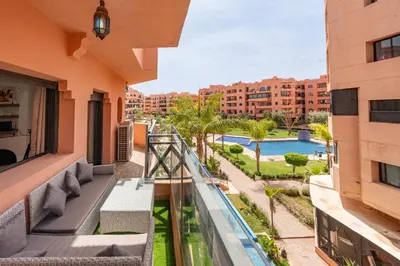 an apartment balcony with a view of a swimming pool at Luxury Residence with 2 Terraces Pool and Garden View Security and Self Check-in in Marrakech