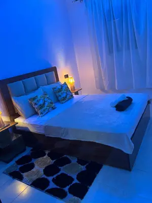 a bedroom with a large bed with blue lighting at Modern central apartment 2 bedrooms in Marrakech