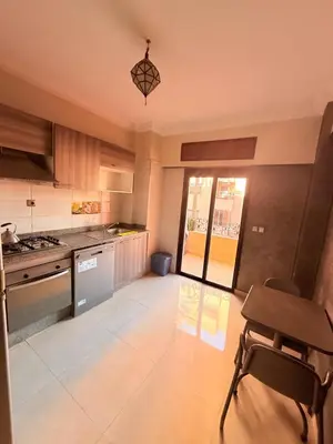 a kitchen with a table and a chair in it at Appartement Spacieux A Majorelle in Marrakech