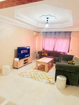 a living room with a couch and a tv at Appartement Spacieux A Majorelle in Marrakech